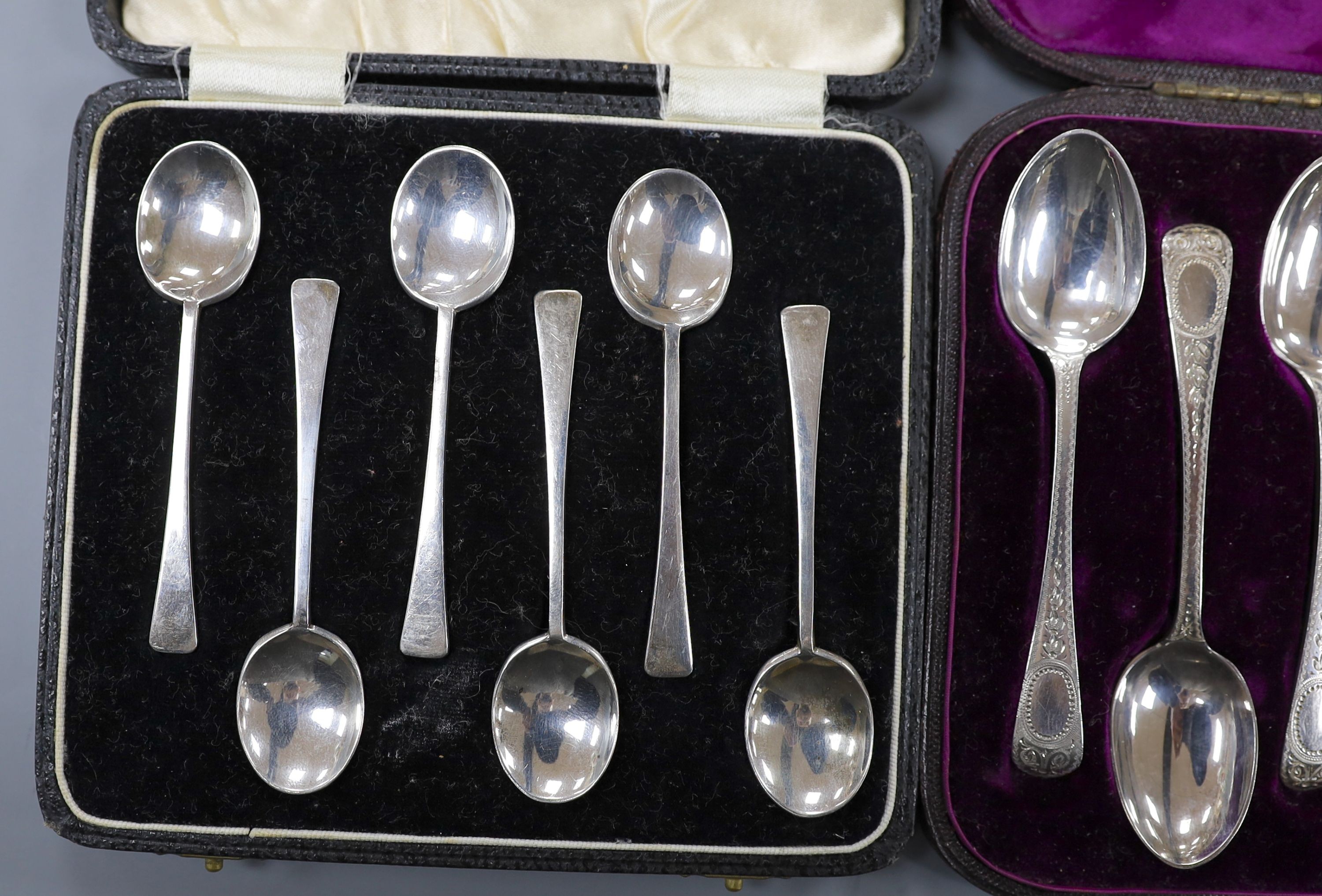 Two cased sets of six silver coffee spoons, Birmingham and a cased set of six engraved silver teaspoons with tongs, London, 1878, 5oz.